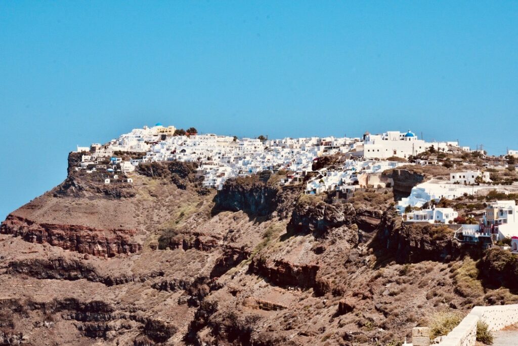 Volcanic layers in Santorini, Greece. Building perched on the edge of the ancient volcano.