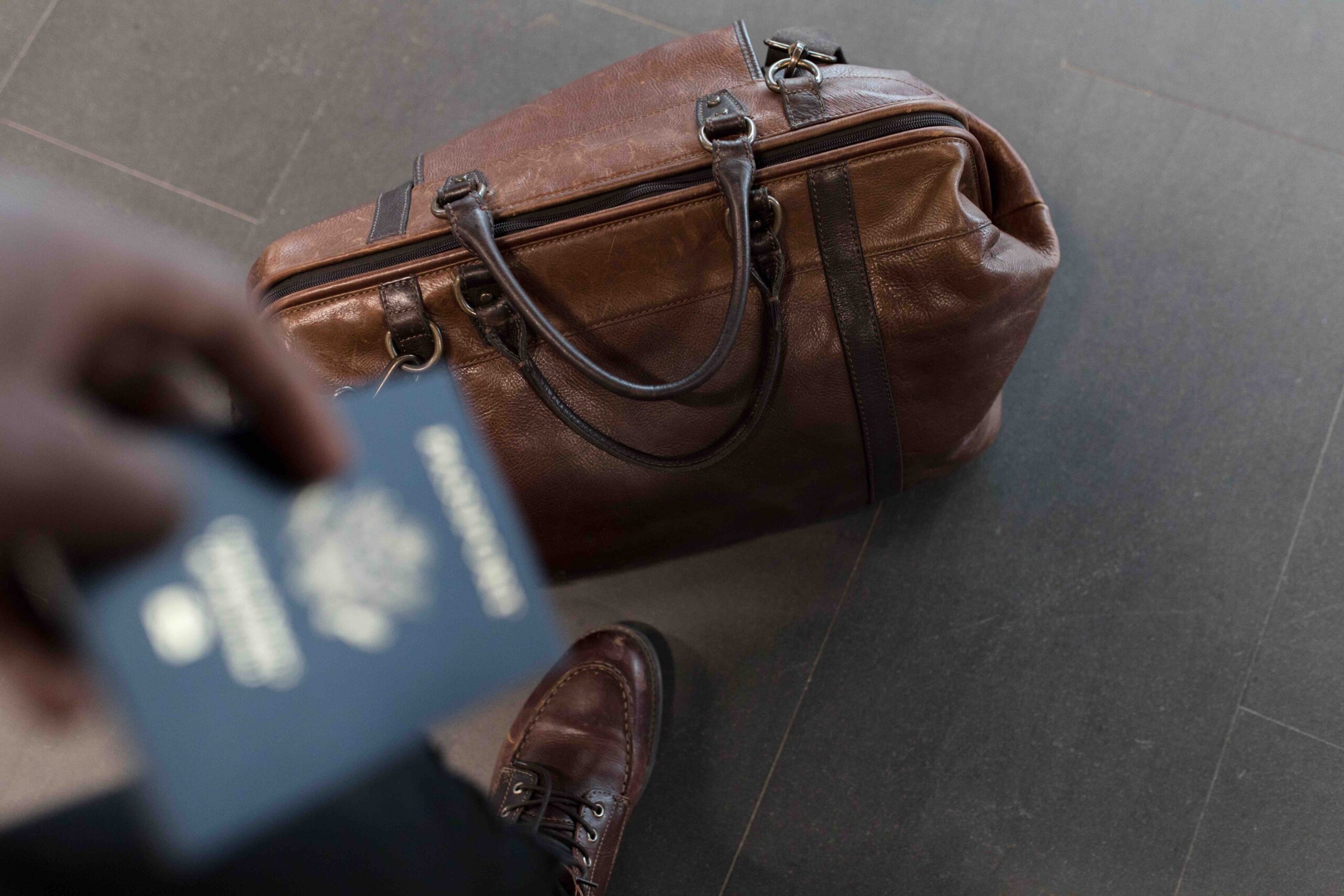 Suitcase at an airport with a passport