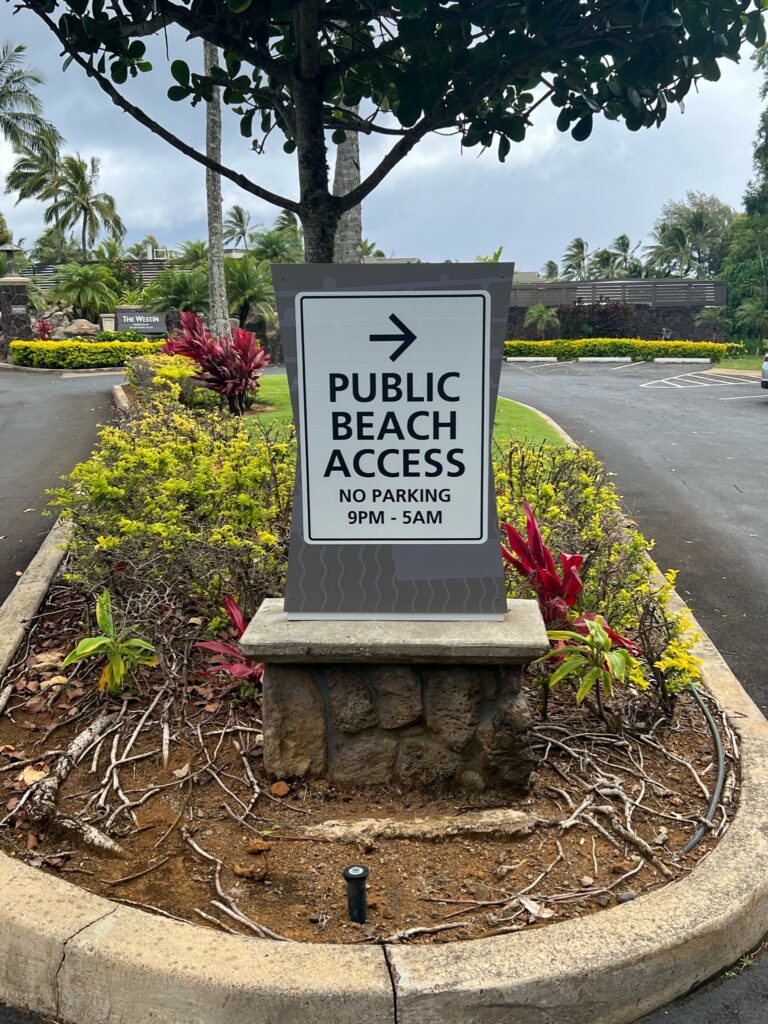 Beach access sign for Princeville hiking trail